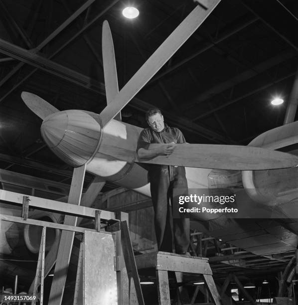 Carpenter at work on the wooden mock up contra-rotating three bladed propellers of the prototype Bristol Brabazon propeller-driven airliner in a...