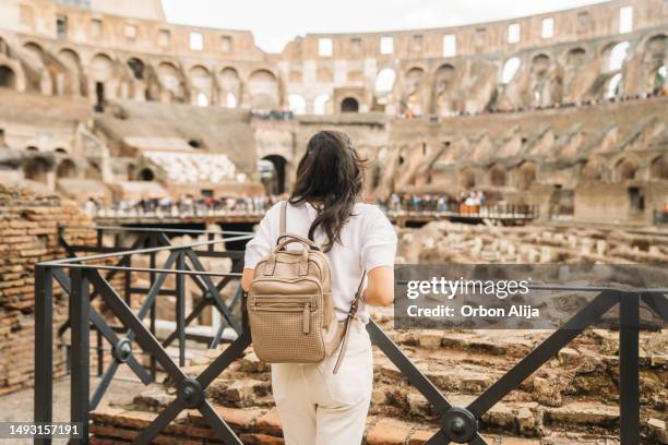 tourist woman in rome by the coliseum - coliseum rome stock pictures, royalty-free photos & images