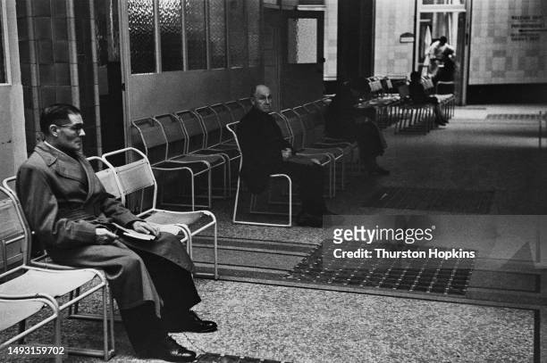 Two men seated in a hospital waiting room, October 1954. Original Publication: Picture Post - 7333 - You And Your Health - unpub. October 9th 1954.