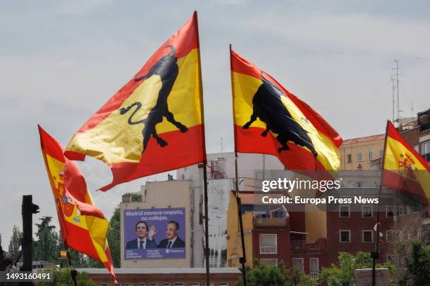 Several flags of Spain in front of the tarpaulin with the image of the president of Real Madrid, Florentino Perez, giving a slap to the mayor of...