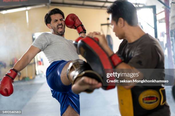 two muay thai boxing athletes during training - boksbroek stockfoto's en -beelden