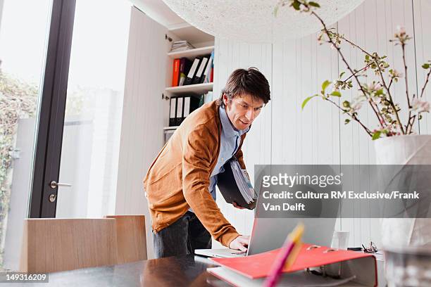 businessman working at desk - leaning stock pictures, royalty-free photos & images