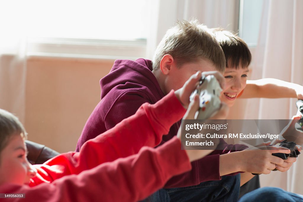 Boys playing video games together