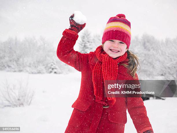 smiling girl throwing snowball - girl scarf stock pictures, royalty-free photos & images