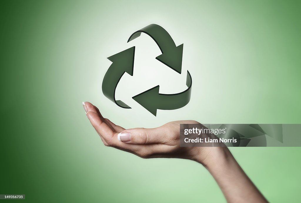 Hand holding recycle symbol
