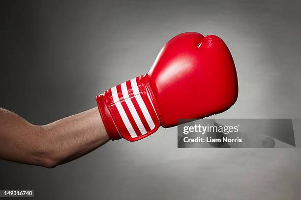 hand wearing boxing glove - boxing gloves foto e immagini stock