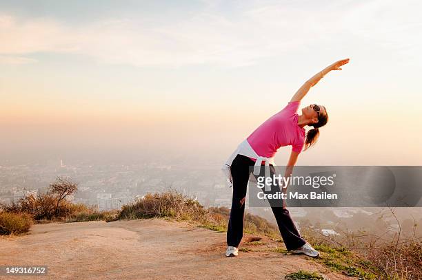 woman stretching on hilltop - runyon canyon stock pictures, royalty-free photos & images
