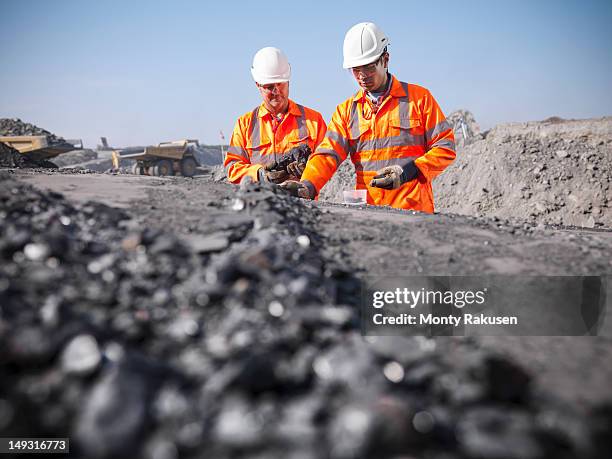 coalminers inspecting coal in an opencast colamine - coal mine stock pictures, royalty-free photos & images