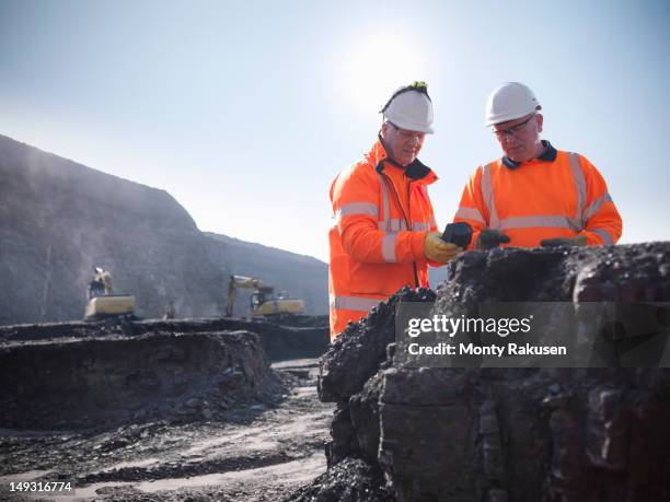 coalminers inspecting coal in an opencast colamine - coal mine stock pictures, royalty-free photos & images