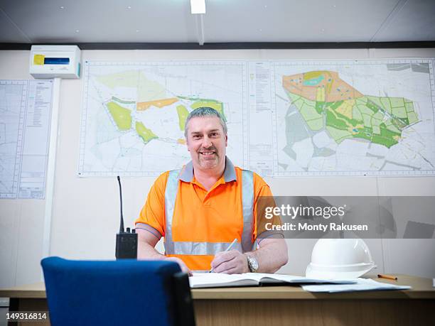 portrait of site manager working at desk in opencast coalmine - northumberland foto e immagini stock