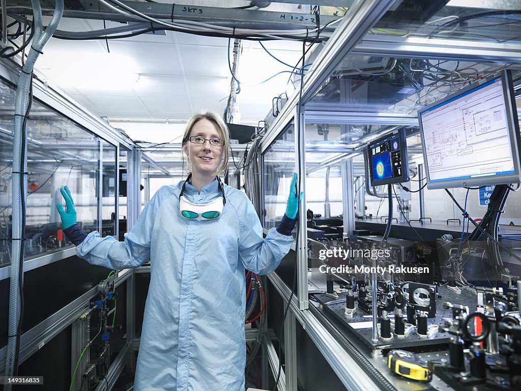 Portrait of female scientist by monitors with laser beam profiles and LabView code