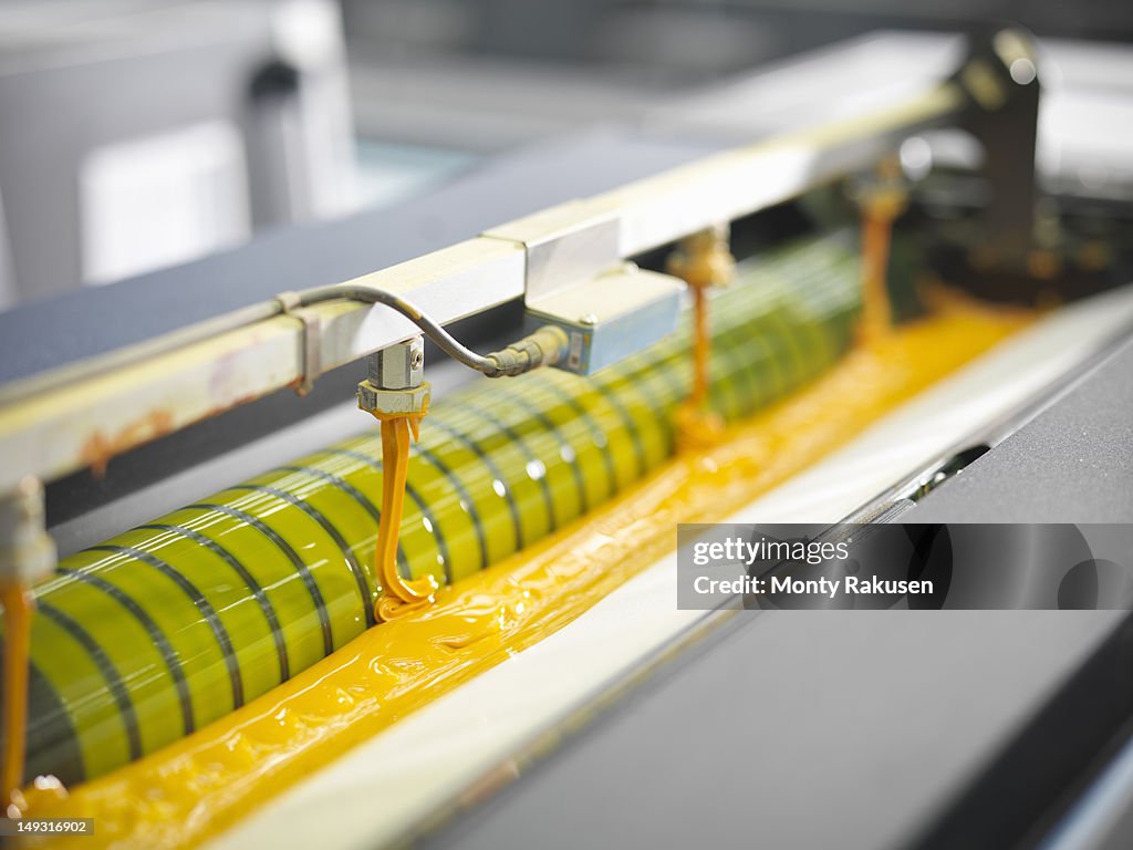 Detail of yellow ink on an industrial printing press