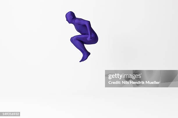 man in bodysuit jumping - bodysuit stock pictures, royalty-free photos & images