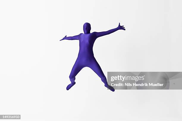 man in bodysuit jumping for joy - bodysuit stock pictures, royalty-free photos & images