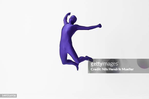 man in bodysuit jumping for joy - zentai stock-fotos und bilder