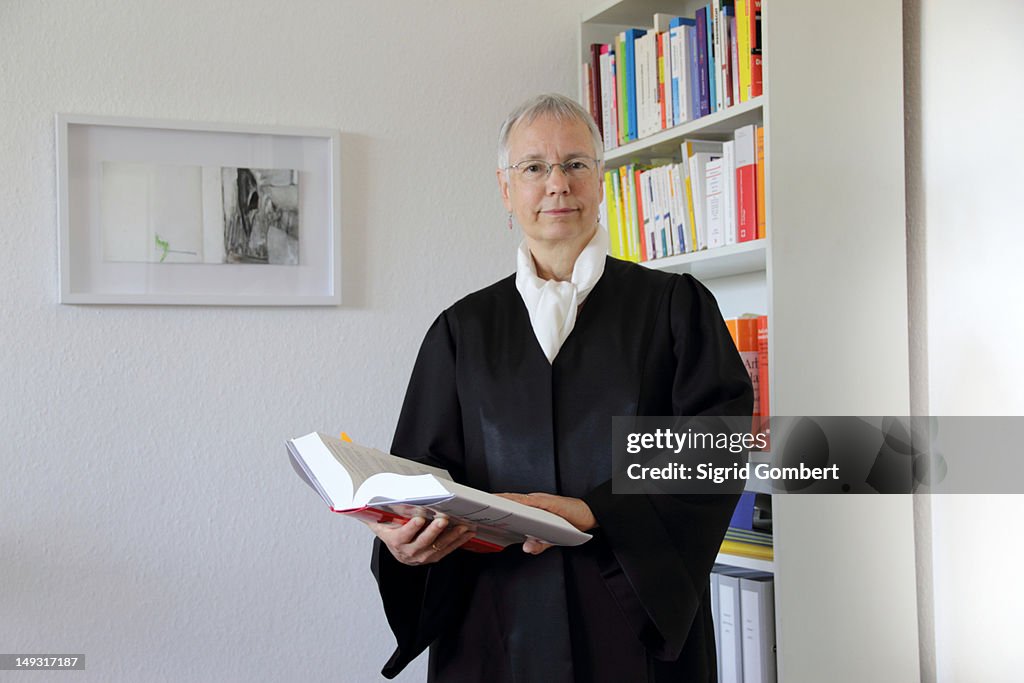 Lawyer reading text book in office