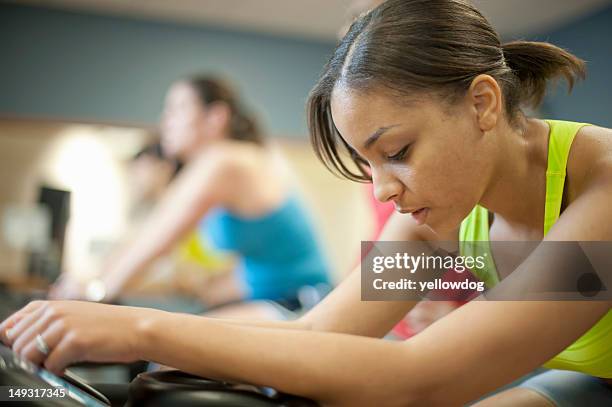 woman using spin machine in gym - woman gasping for air stock pictures, royalty-free photos & images