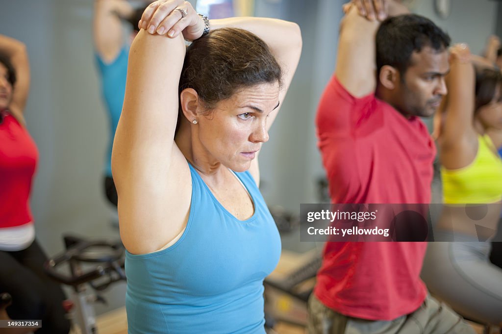 People stretching on spin machines