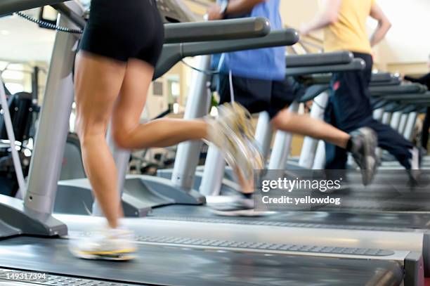 blurred view of people on treadmills - 3 gym stock-fotos und bilder