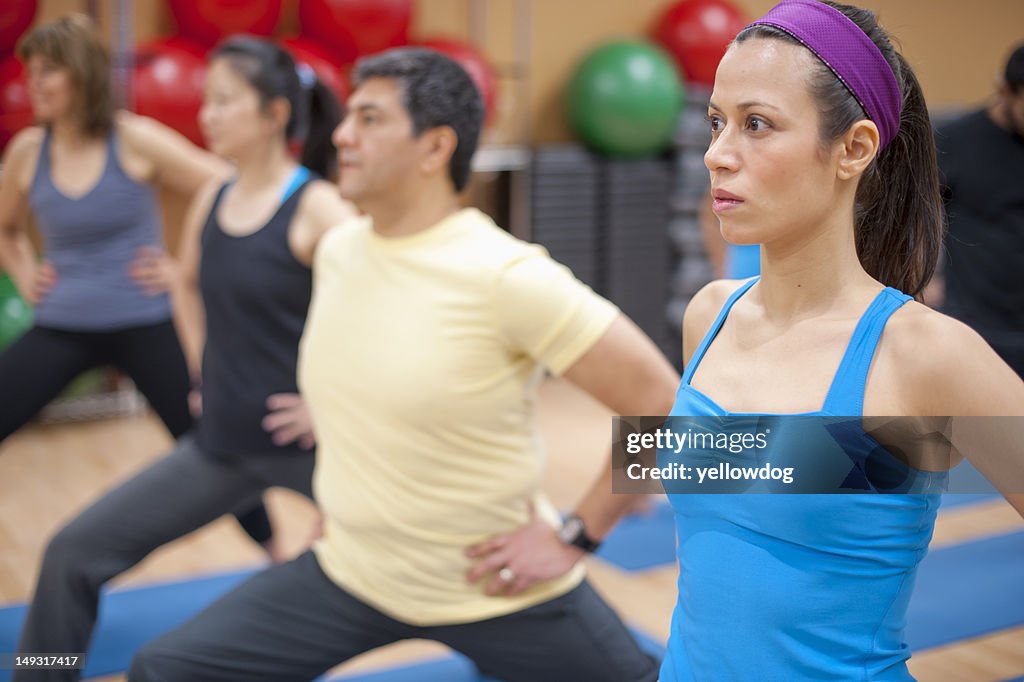 People practicing yoga in studio