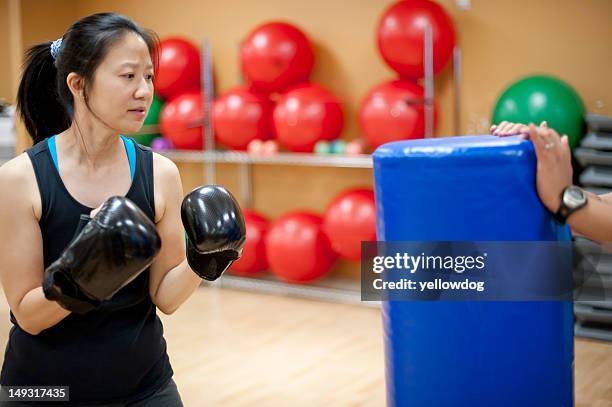 woman punching bag in gym - punching bag stock pictures, royalty-free photos & images