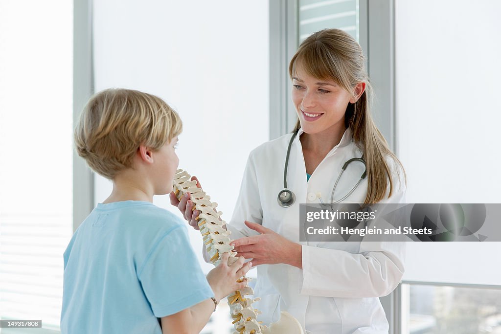 Doctor showing skeletal model to patient