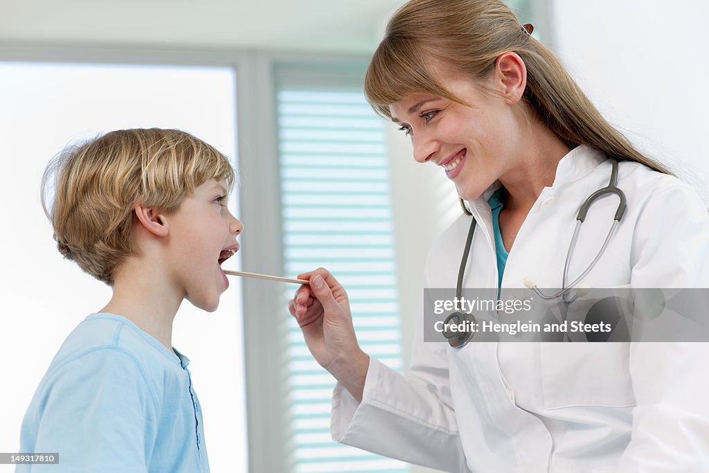 Doctor examining boy in office