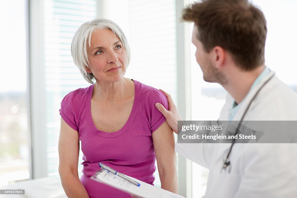 Doctor talking to woman in office