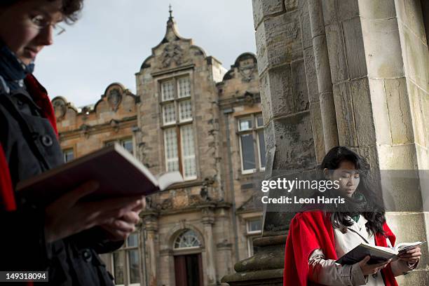 university students in traditional capes - st andrews scotland stock pictures, royalty-free photos & images