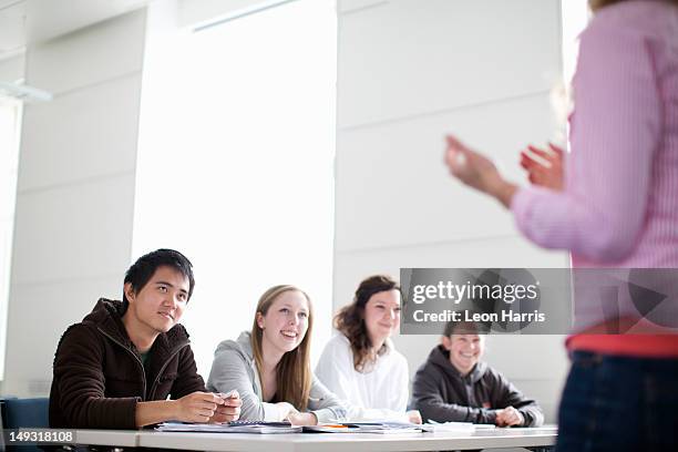 teacher talking to students in class - st andrews scotland stock pictures, royalty-free photos & images