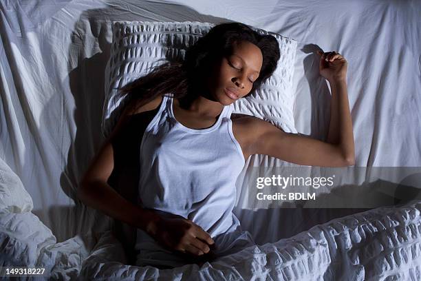 woman sleeping in bed - above view of man sleeping on bed stock-fotos und bilder