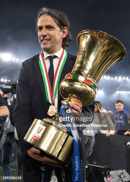 Simone Inzaghi Head coach of FC Internazionale poses with the trophy following the 2-1 victory in the Coppa Italia Final match between ACF Fiorentina...