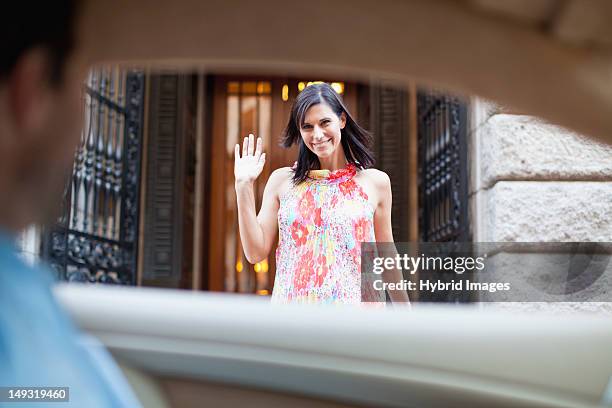 woman waving to boyfriend in car - girlfriend leaving stock pictures, royalty-free photos & images