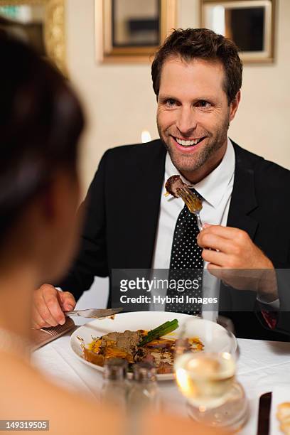couple having dinner in restaurant - mid adult couple stock pictures, royalty-free photos & images