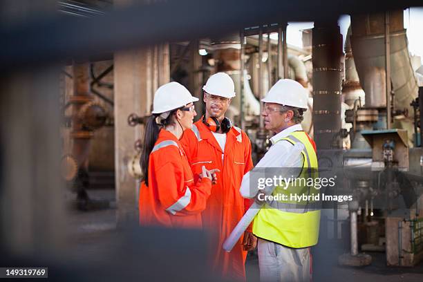 workers talking at oil refinery - oil rig worker bildbanksfoton och bilder