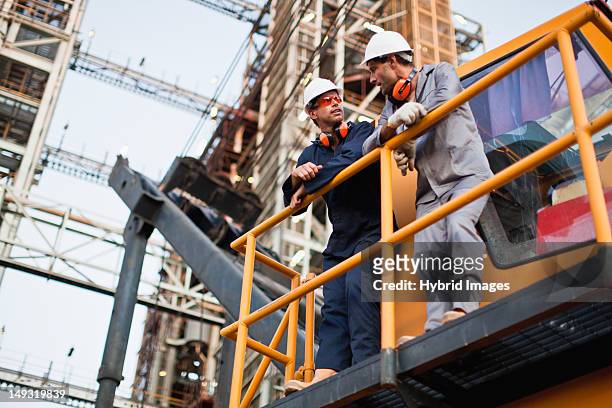 workers talking at oil refinery - gas plant stock pictures, royalty-free photos & images
