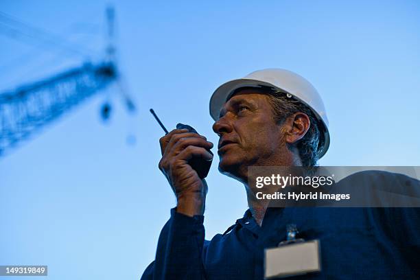 worker using walkie talkie on site - oil rig worker bildbanksfoton och bilder