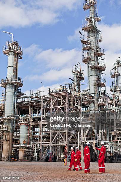 workers talking at oil refinery - oil refinery stock pictures, royalty-free photos & images