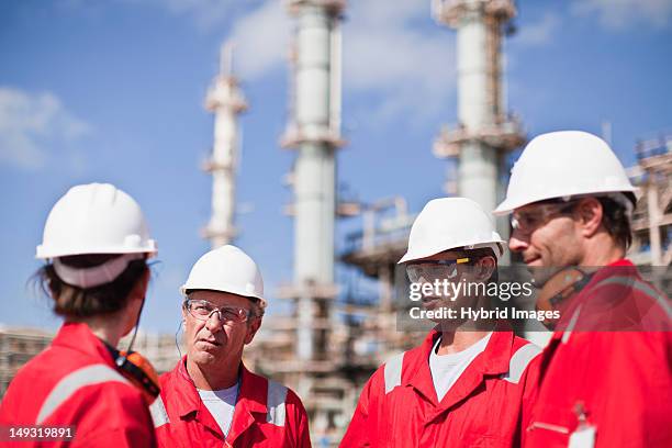 workers talking at oil refinery - gas plant stock pictures, royalty-free photos & images