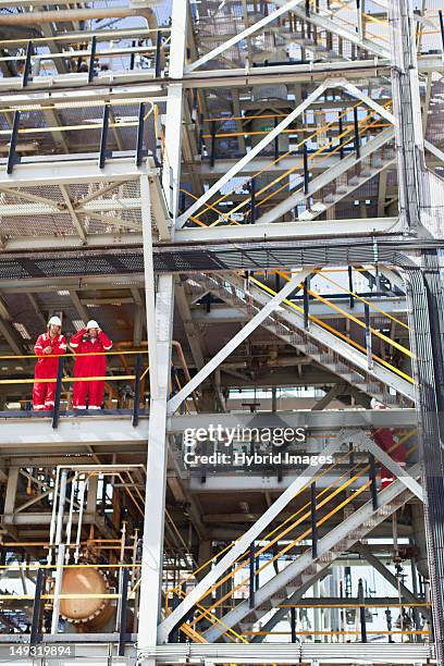 workers talking at oil refinery - conference 2012 day 3 stockfoto's en -beelden