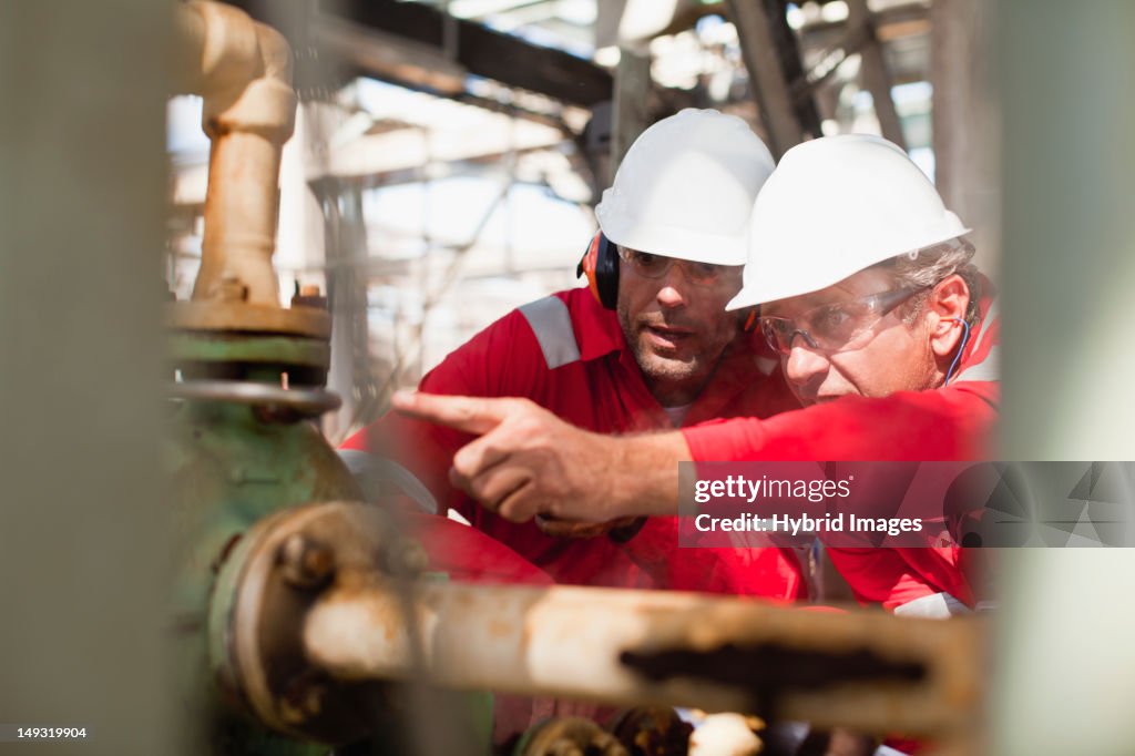 Workers examining equipment on site