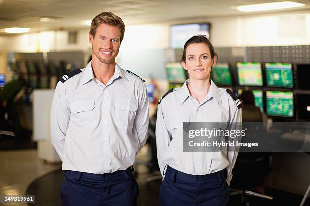 security personnel in control room - bewaker stockfoto's en -beelden