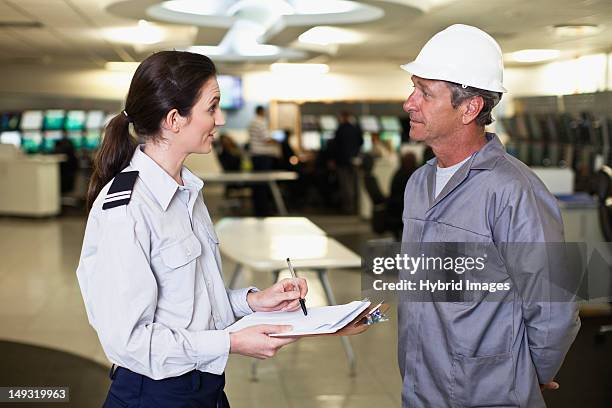 security personnel talking to worker - security man stock pictures, royalty-free photos & images