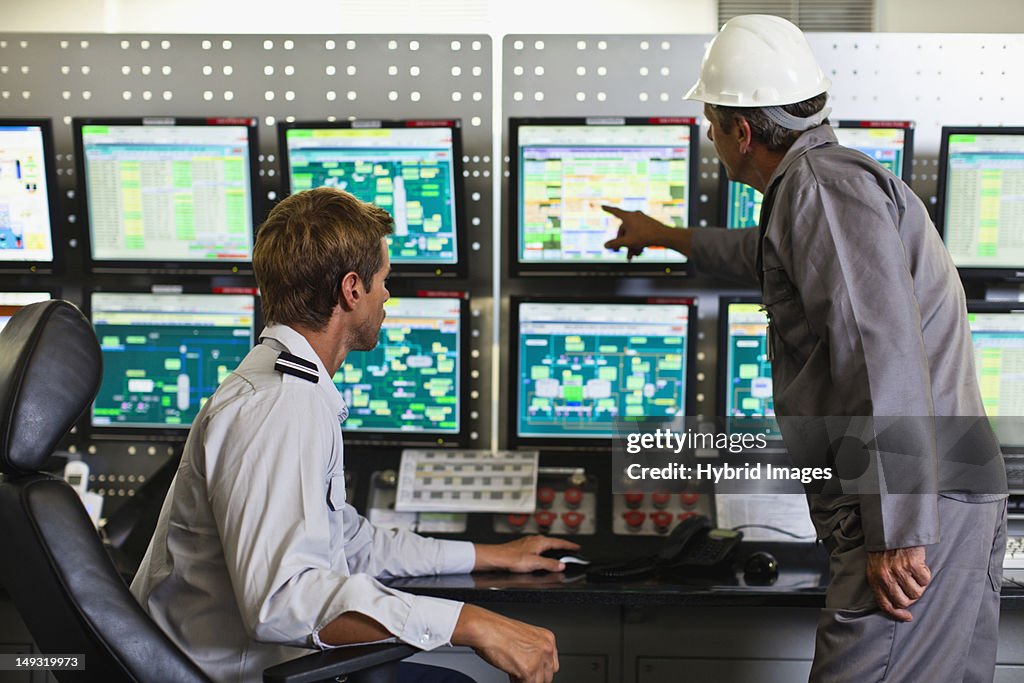 Men working in security control room