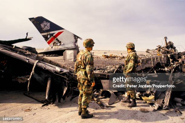 United States Army troops examine the wreckage of a British Airways Boeing 747 aircraft, registration G-AWND, on an apron at Kuwait International...