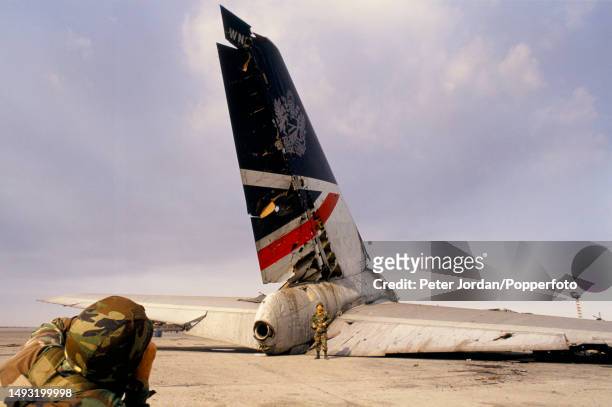 United States Army troops examine the wreckage of a British Airways Boeing 747 aircraft, registration G-AWND, on an apron at Kuwait International...