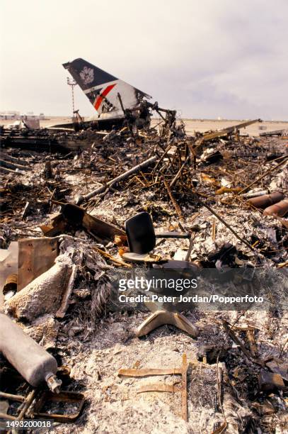 Black office chair placed amongst the wreckage of a British Airways Boeing 747 aircraft, registration G-AWND, on an apron at Kuwait International...