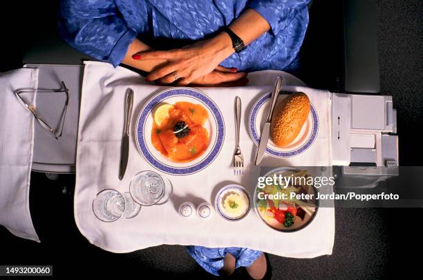 View from above of a female passenger being served a meal in the mock up first class cabin of a British Airways aircraft at Heathrow Airport in west...