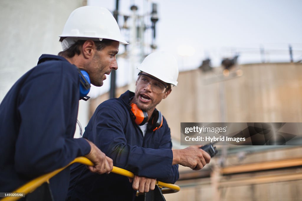 Workers talking at chemical plant