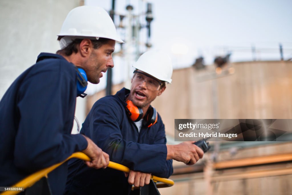 Workers talking at chemical plant